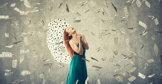 a woman standing in the money rain